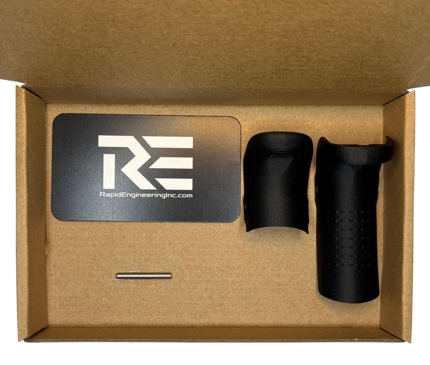 Backstrap kit contents shown in packaging: Rapid Engineering Inc. branded card, Glock 19x and 17 compatible beavertail backstrap, and installation pin arranged inside a cardboard box.